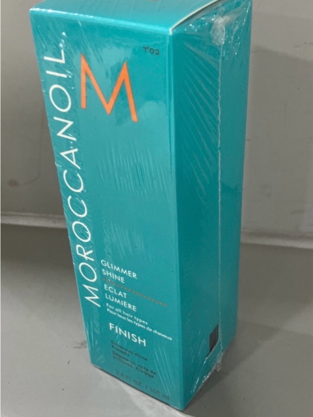 Moroccanoil Glimmer Shine Finish - Teal with Orange Logo